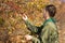 Scout checking autumn berries on a bush