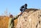 Scout helping a young boy rock climbing