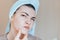 Scowling girl in shock of her acne with a towel on her head. Woman skin care concept photos of ugly problem skin girl