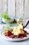 Scramble of eggs with carpaccio of baked beets with walnuts, aromatic herbs and arugula on a plate. Delicious healthy breakfast.