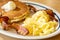 Scramble eggs, hot cakes and bacon