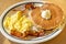 Scramble eggs, hot cakes and bacon