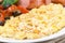 Scramble eggs with tomatoes, sausage and toast, close-up