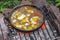 Scrambled eggs on a campfire camping in the nature Shakshouka national cuisine