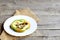 Scrambled eggs with mushrooms in green pepper. Scrambled eggs on a plate isolated on old wooden background with blank copy space