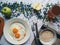 scrambled eggs, oatmeal, apple and cup of tea on the table