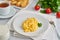 Scrambled eggs, omelet, side view. Breakfast with pan-fried eggs, glass of milk, tomatoes on white background
