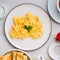 Scrambled eggs, Omelette. Breakfast with pan-fried eggs, cup of