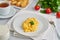 Scrambled eggs, omelette, side view. Breakfast with pan-fried eggs, glass of milk, tomatoes on white background