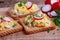 Scrambled eggs with radish and chives on toasted bread
