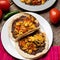 Scrambled eggs and refried beans tacos on wooden background. Mexican food