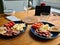 Scrambled eggs scramble breakfast meal red tomatoes bread on blue plates on a wooden table glass