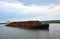 Scrap metal on a barge on a river in Germany