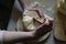 Scraping Device of Swiss Cheese Tete de moine. A man cuts cheese.