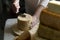 Scraping Device of Swiss Cheese Tete de moine. A man cuts cheese.