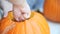 Scraping seeds from Halloween pumpkin A man removes seeds and fibrous material before carving his jack o` lantern.