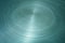 Scratched round metal surface cyan toned