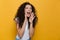 Screaming excited young cute woman posing isolated over yellow background.