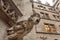 Screaming grotesque carved figure projecting from the gutter of building, Stone gargoyle on building in Bavaria, Germany