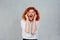 Screaming stressed. Portrait frustrated shocked redhead business woman yelling eyes closed hands on head temper tantrum isolated