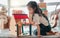 Screen time is not the only way to keep them entertained. an adorable little girl playing a dollhouse.