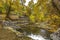 Screened in rocks lining a clear shallow stream