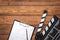 Screenwriter desktop with movie clapper board wooden background top view