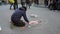 A screever chalk artist drawing on a footpath in Florence, Italy