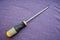 Screwdriver with a rubberized yellow-gray handle