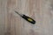 Screwdriver tool on blurred wooden background.