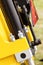 Screws, bolts and piston or actuator as part of yellow agricultural machinery, technology and engineering concept