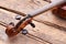 Scroll of the old violin on wooden floor.