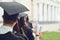 Scrolls of diplomas in the hands of a group of graduates.