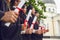 Scrolls of diplomas in the hands of a group of graduates.