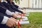 Scrolls of diplomas in the hands of a group of graduates.