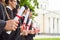 Scrolls of diplomas in the hands of a group of graduates.