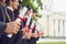 Scrolls of diplomas in the hands of a group of graduates.