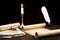 Scrolls of parchment and old papers on the background of a lit candle and inkwell pen