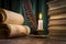 Scrolls of parchment, a stack of books, and a lit candle