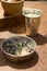 Scrub of natural ingredients in indian bowl, vessel with water,   lavander and chamomile   flowers  on iron rustic