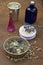 Scrub of natural ingredients in indian bowl, vessel with water,  soap ,  lavander and chamomile   flowers, blue glass bottle on