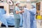 Scrub Nurse Assisting Surgeon with Gown