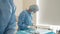 Scrub nurse preparing medical instruments for operation. Close-up Shot in Operating Room of Surgical Table with