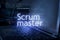 Scrum master inscription against laptop and code background. Scrum is facilitated by a scrum master