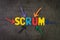 Scrum master method for agile software development concept, multi color arrows pointing to the word Scrum at the center of black