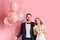 Sctrict fiance and happy bride isolated over pink background