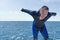 Scuba diver on boat, putting on his wetsuit.