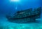 Scuba diver exploring a sunken shipwreck at the Maldives islands, Indian Ocean