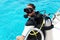 Scuba diver is preparing for diving into blue water from the boat. Underwater equipment