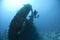 Scuba diver at the propellor area of a shipwreck.